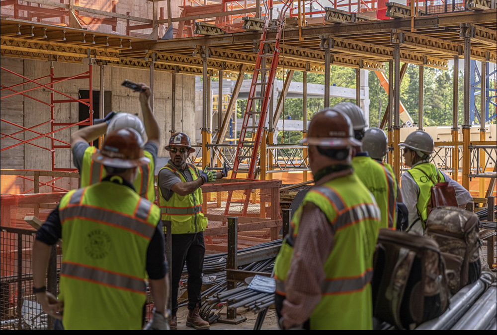 Owner Tobias providing instructions to. his construction crew